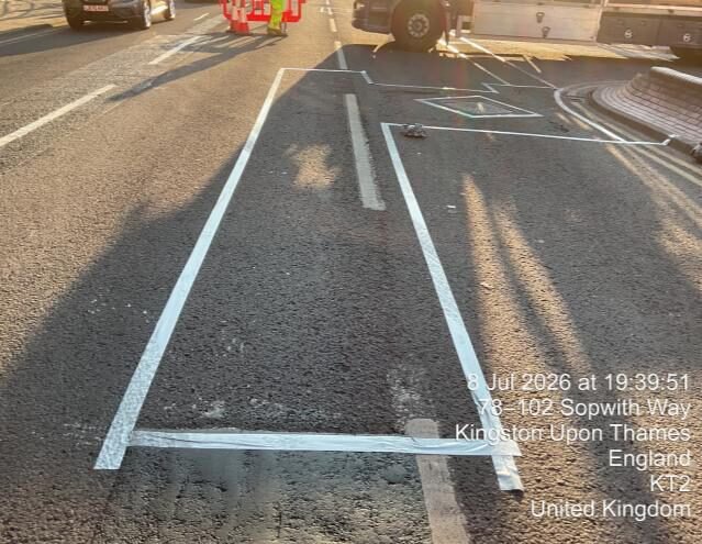 Marked carriageway repair area on Sopwith Way before Elastomac treatment