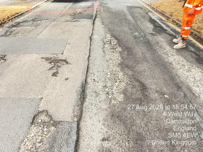 Worn patched carriageway surface before repair at West Way Sutton