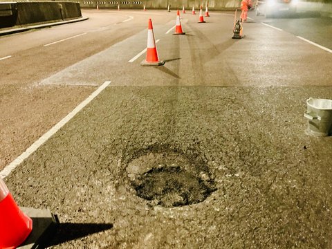 Open pothole requiring permanent pothole repair